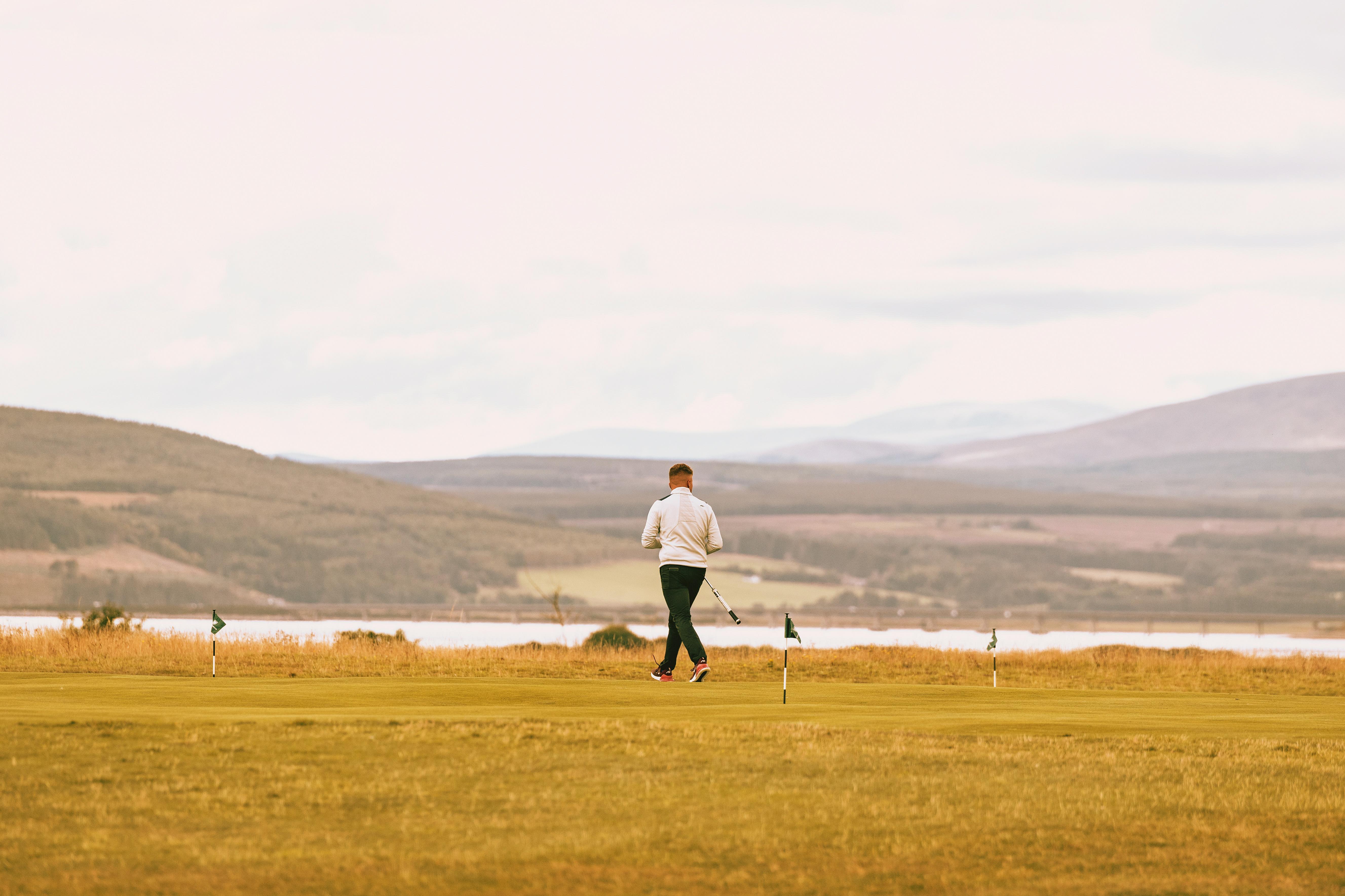 Dornoch Station Hotel Exterior photo A player on the 18th fairway